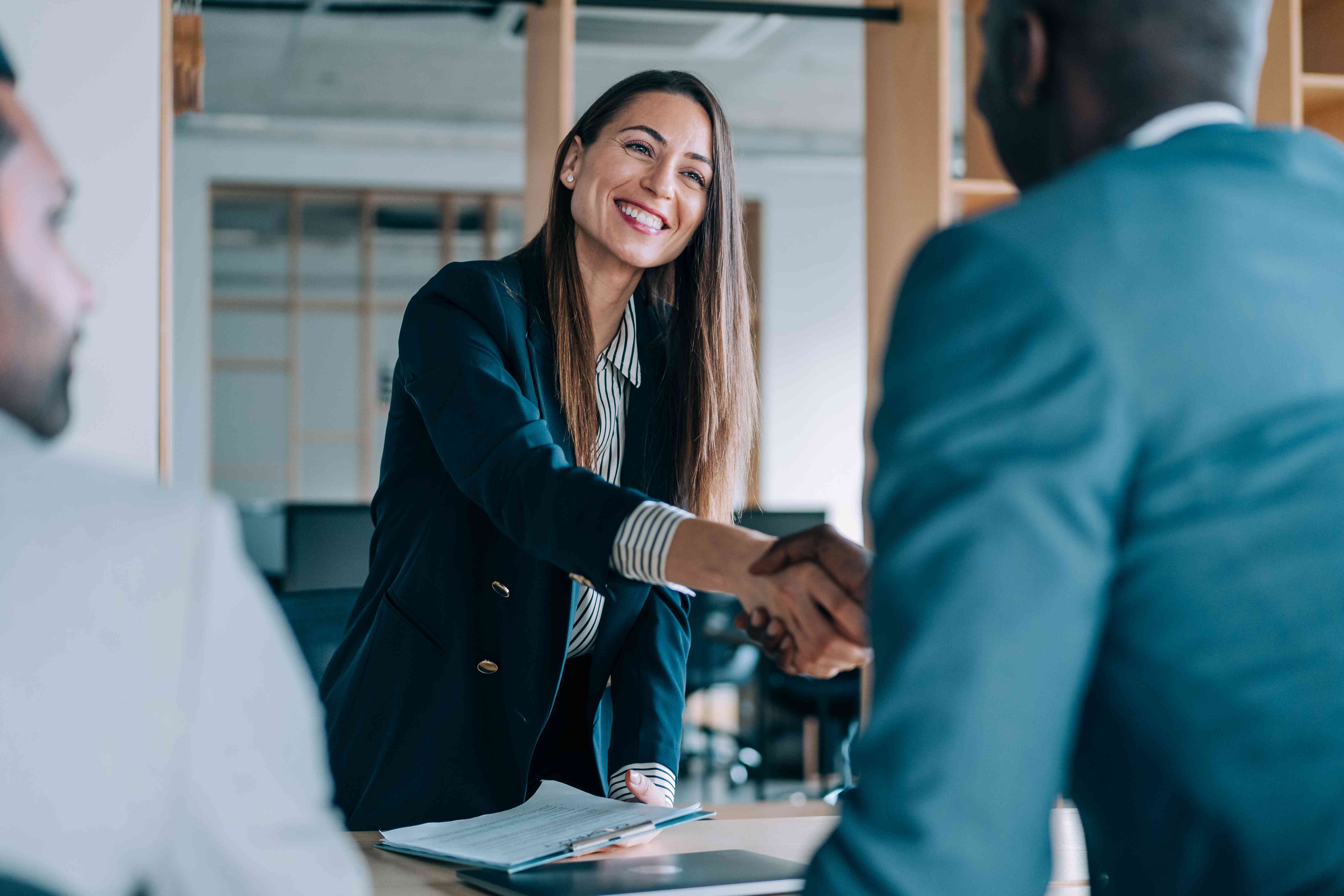 Business people shaking hands in the office. 