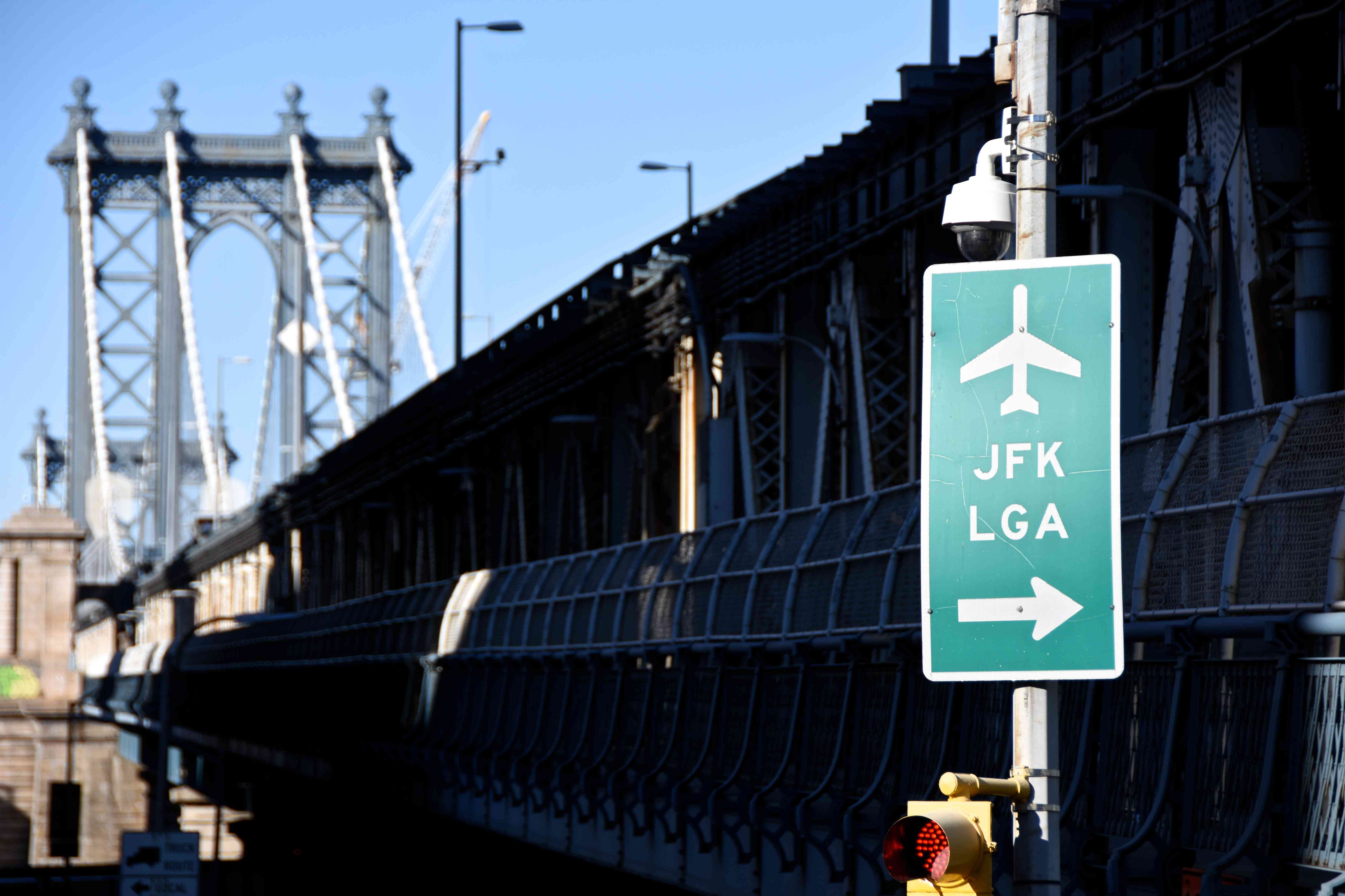 Road Sign Against Bridge and Sky in City