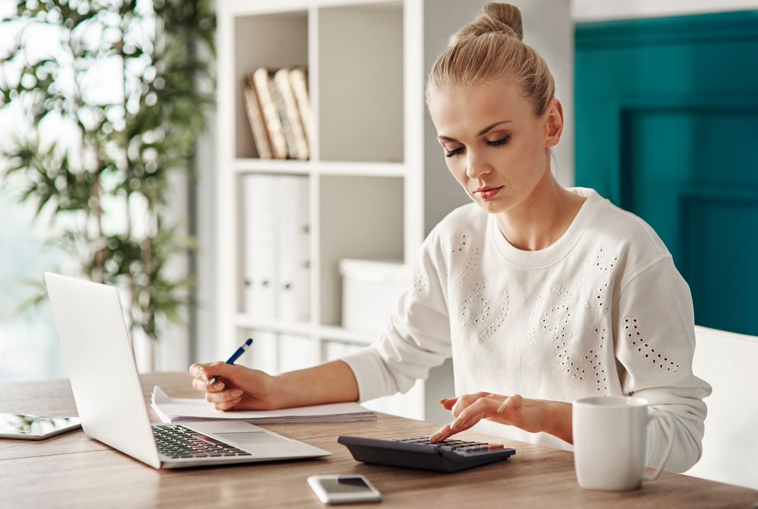 Businesswoman Using Laptop At Desk In Office