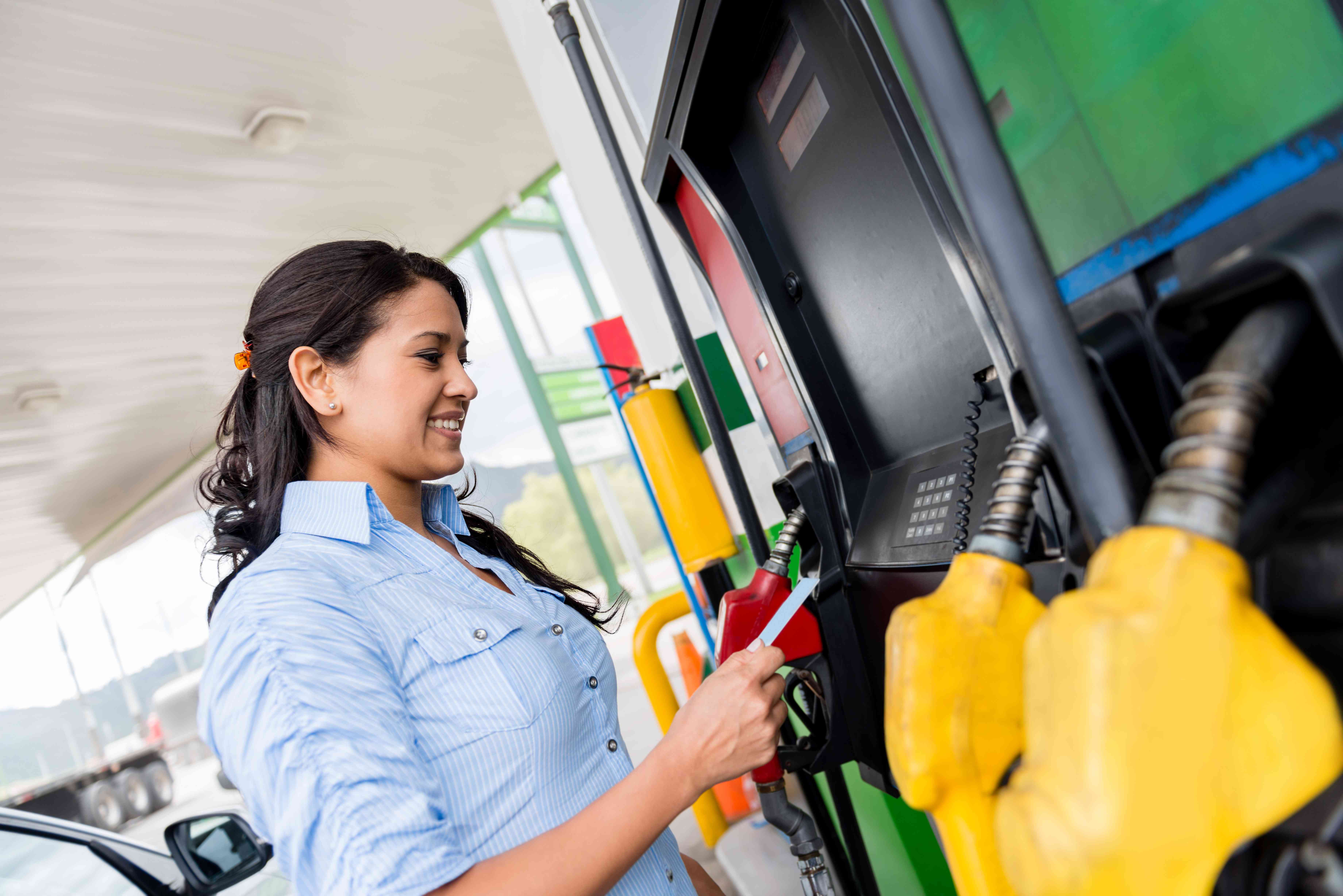 Woman pumping gas